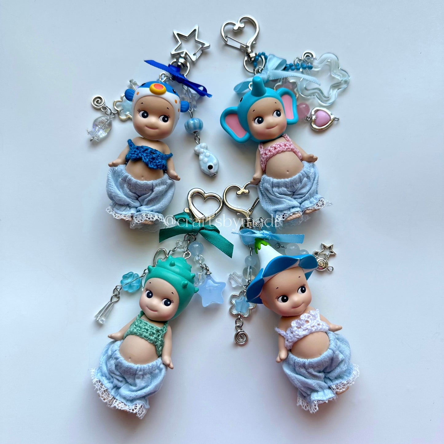 blue sonny angel keychains with crochet tops and blue pants