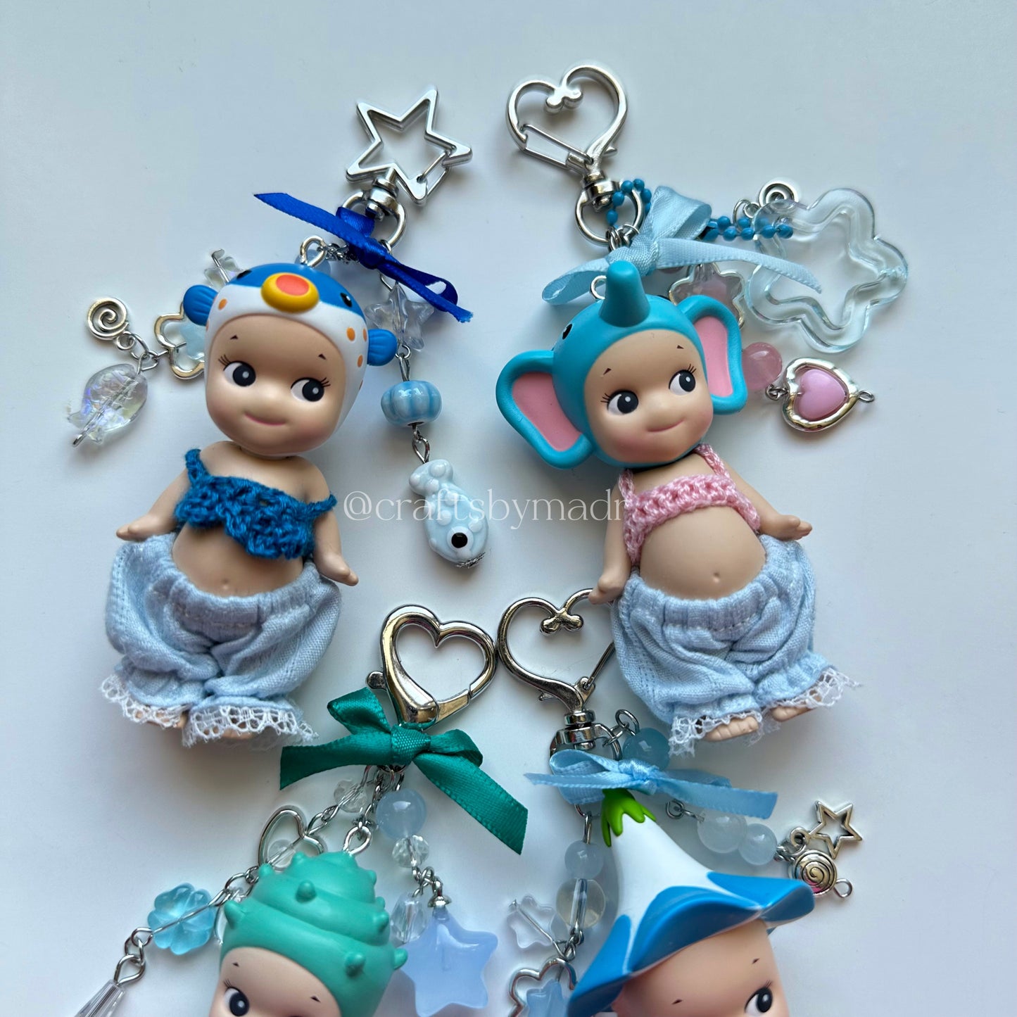 blue sonny angel keychains with crochet tops and blue pants